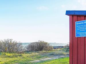 a sign in a field next to a red box at 3 person holiday home in ONSALA in Onsala