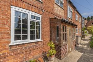 a brick building with a window and a door at The Southend Cottage in Ledbury