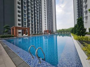a swimming pool in the middle of two tall buildings at 3R2B Mirai Residence Kajang 2 in Kajang