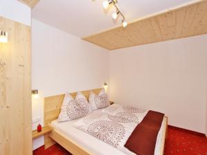 a bedroom with a bed with white sheets and pillows at Chalet in Wald near Zillertal Ski Area in Wald im Pinzgau