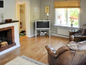 a living room with a couch and a television at 5 person holiday home in ARVIKA-By Traum in Arvika