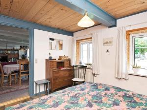a bedroom with a bed and a dining room at 4 person holiday home in Bredebro-By Traum in Ballum