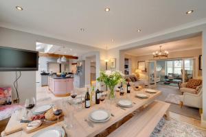 a kitchen and living room with a table with wine bottles at Church Beck Retreat in Scalby