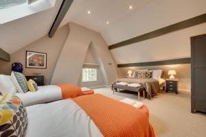 a attic bedroom with two beds and a couch at Church Beck Retreat in Scalby