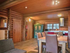 a kitchen and dining room with a table and chairs at Chalet in Wörgl near Ski Lift in Hopfgarten im Brixental +23 photos