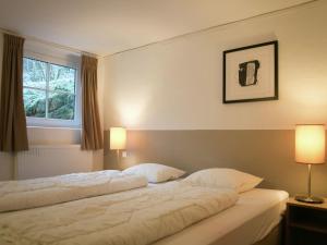 a hotel room with a large bed with two pillows at Chalet in Wörgl near Ski Lift in Hopfgarten im Brixental