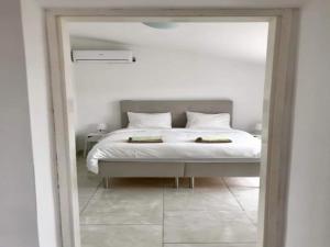 a bedroom with a white bed and a mirror at Villa in Orebić near Sea Beach in Orebić