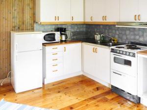 a kitchen with white cabinets and a stove top oven at 4 person holiday home in HÖGKLINT-By Traum in Axelsro