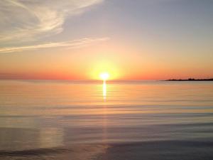 a sunset over the water with the sun setting at 4 person holiday home in HÖGKLINT-By Traum in Axelsro