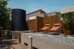 a group of chairs sitting on top of a building at Cholula Condesa Hotel by Lumina in Mexico City