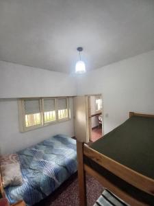 a bedroom with a bed and a window at Alquiler en las Toninas a 2 cuadras del mar in Las Toninas