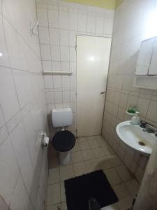 a small bathroom with a toilet and a sink at Alquiler en las Toninas a 2 cuadras del mar in Las Toninas