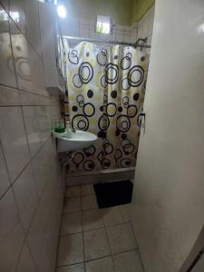 a bathroom with a sink and a shower curtain at Alquiler en las Toninas a 2 cuadras del mar in Las Toninas