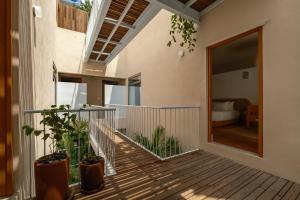 a house with a balcony with plants on it at Cholula Condesa Hotel by Lumina in Mexico City