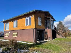 a small house with a porch on a field at Rusutsu Golf&Ski Lodge - Vacation STAY 18169 in Rusutsu