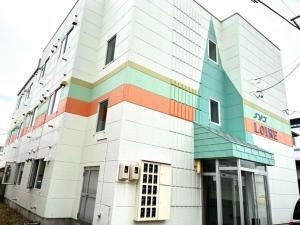 a multicolored building with a sign on it at Maison Loire - Vacation STAY 18226 in Hakodate