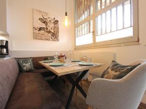 a living room with a table and a couch at Apartment in Kirchdorf near Ski Slopes in Kirchdorf in Tirol