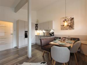 a kitchen and living room with a table and chairs at Apartment in Kirchdorf near Ski Slopes in Kirchdorf in Tirol