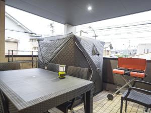 a table with a tent on a balcony with a grill at Kotonoyado Chizu - Vacation STAY 83866v in Kotohira +1 photo