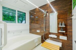 a bathroom with a shower and a tub and a sink at Variety Road Bette Gento - Vacation STAY 83175v in Kawasaki +36 photos