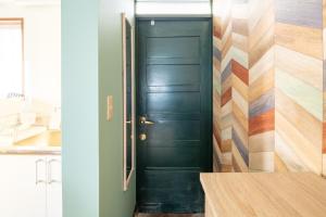 a black door in a kitchen with colorful tiles at Villent Ito Kawana - Vacation STAY 91110v in Ito
