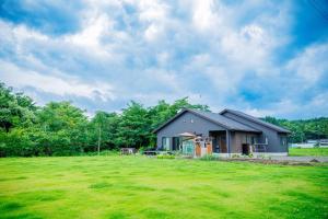 a house in a field with a large yard at Variety Road Bette Gento - Vacation STAY 83175v in Kawasaki
