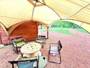a tent with chairs and a table in front of it at Our Minano Base - Vacation STAY 92839v in Minano
