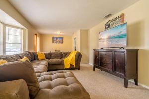 a living room with a couch and a flat screen tv at SA Randolph New Braunfels Vacation home with King Bd Sleeps 10 in San Antonio