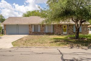a brick house with a tree in front of it at SA Randolph New Braunfels Vacation home with King Bd Sleeps 10 in San Antonio