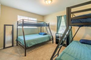 a bedroom with two bunk beds and a mirror at SA Randolph New Braunfels Vacation home with King Bd Sleeps 10 in San Antonio