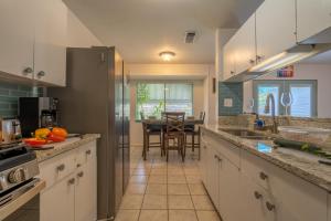 a kitchen with white cabinets and a dining room at SA Randolph New Braunfels Vacation home with King Bd Sleeps 10 in San Antonio