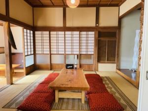 a room with a wooden table and red rugs at DOG LEG - Vacation STAY 98415v in Funakata