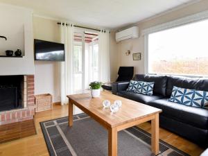a living room with a couch and a coffee table at 5 person holiday home in GLOMMEN-By Traum in Glommen