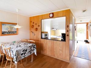 a dining room with a table and a mirror at 5 person holiday home in GLOMMEN-By Traum in Glommen +9 photos