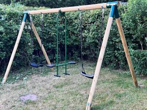 an old swing set with two swings at 8 person holiday home in Skals in Skals +24 photos