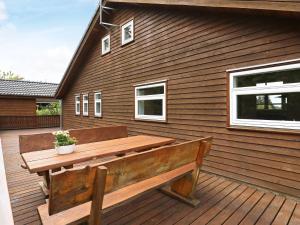 a wooden bench sitting on a wooden deck at 8 person holiday home in Skals in Skals