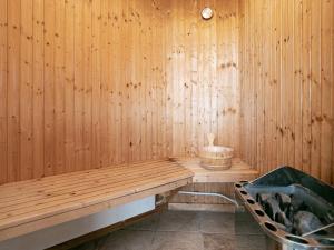 a sauna with a wooden bench and a tub at 4 star holiday home in Skals in Skals