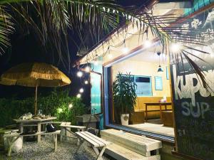a patio with benches and a table and an umbrella at kupono - Vacation STAY 00637v in Minamiboso