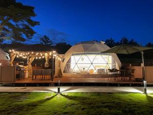 a yurt with a table and chairs and lights at Gramercy Village Lake Yamanaka Glamping & Sauna - Vacation STAY 92831v in Yamanakako