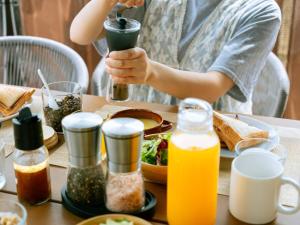 a person sitting at a table with a plate of food at Gramercy Village Lake Yamanaka Glamping & Sauna - Vacation STAY 92831v in Yamanakako