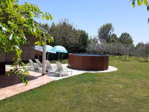 a patio with a hot tub in a yard at Charming Pool Home Near Pula in Pula