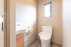 a bathroom with a toilet and a sink and a window at Green Peak - Vacation STAY 05851v in Minami Aso +16 photos