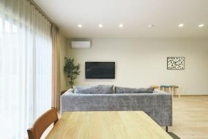 a living room with a couch and a table at Green Peak - Vacation STAY 05851v in Minami Aso