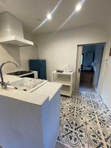 a kitchen with a white counter and a tile floor at Kitakyushu - House - Vacation STAY 18471 in Kitakyushu +4 photos