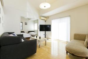 a living room with a couch and a tv at HANA - Vacation STAY 18403 in Nagoya
