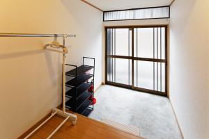 an empty room with a window and wine racks at minpaku Blanco Honjin - Vacation STAY 18357 in Nagoya