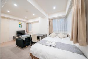a bedroom with a bed and a desk with a computer at Pangoo Shinagawa Room 205 - Vacation STAY 18364 in Tokyo +12 photos