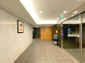 a hallway of an office building with a glass door at Pangoo Shinagawa Room 205 - Vacation STAY 18364 in Tokyo