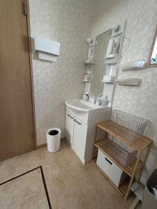 a small bathroom with a sink and a mirror at OUCHI Oaramachi - Vacation STAY 18642 in Goto