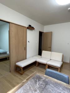 a room with two white couches and a bed at OUCHI Oaramachi - Vacation STAY 18642 in Goto +2 photos